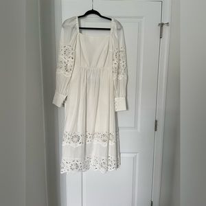 Lace white dress with cut out detail. Purchased at Beau & Ro. Never worn. NWT